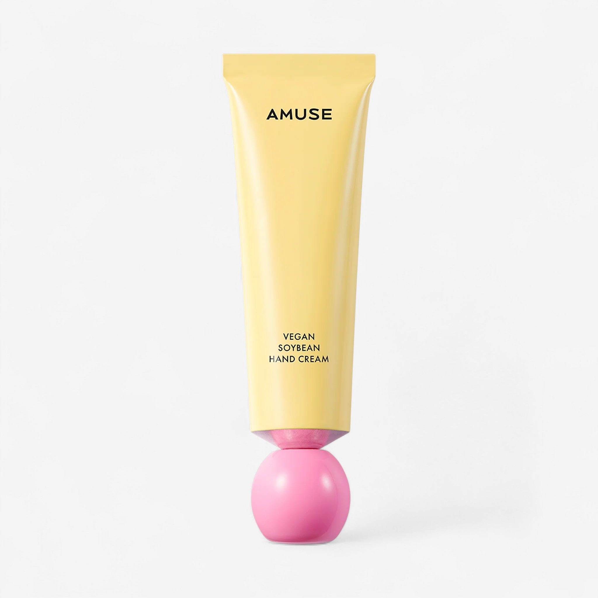Yellow and pink hand cream tube with 'AMUSE' branding on a white background. k-beauty vegan handcream.